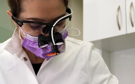 Dr. Antipova working under loupes